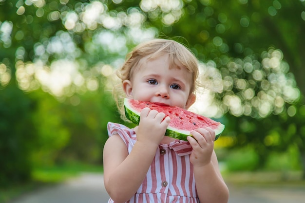 Child girl eats watermelon in summer Selective focus