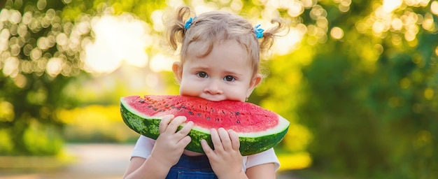 Child girl eats watermelon in summer Selective focus