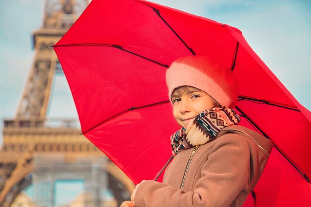 Child girl on the Eiffel Tower in Paris. Selective focus.