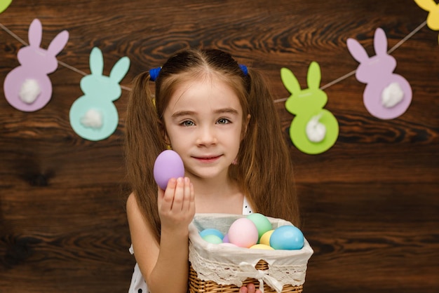 Child girl holding basket with easter
