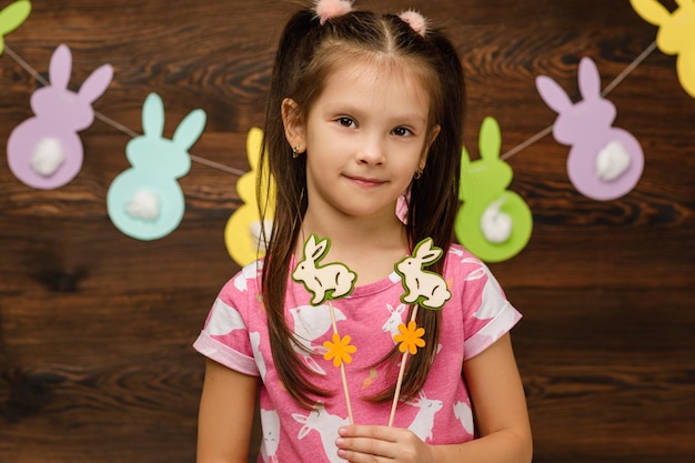 Child girl holding a bunny figurine