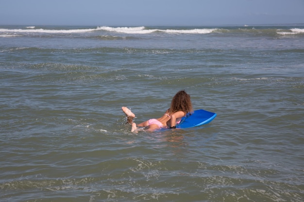 child girl play surf body board in sea beach