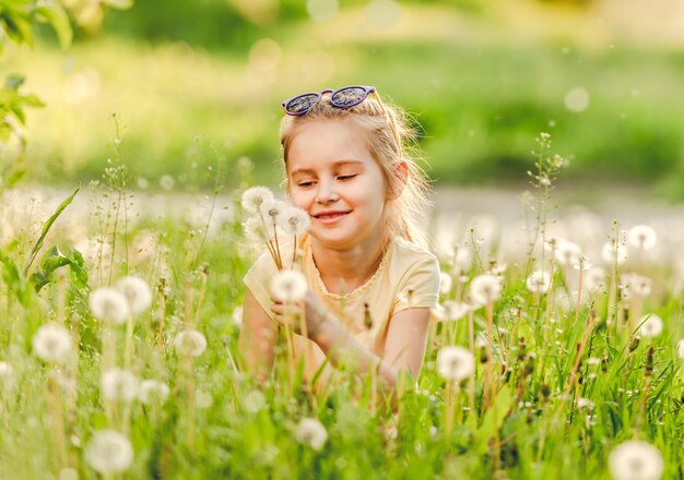 Child girl playing on green field