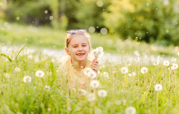 Child girl playing on green field