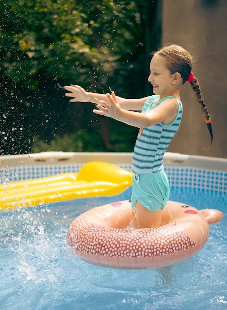 Child girl playing in pool