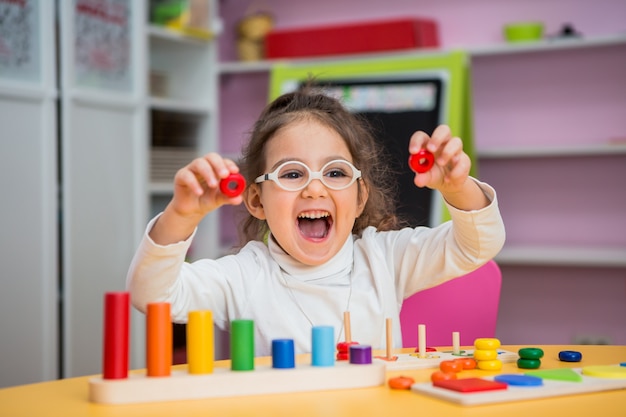 child girl  plays in educational classes