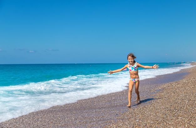 Child girl at the sea. Selective focus.