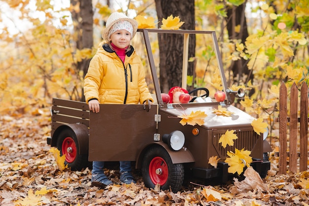 A child girl walks in the autumn park