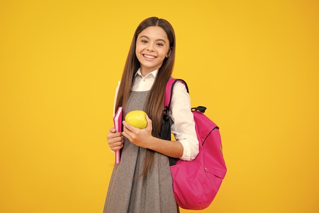 Child girl with an apple over isolated white background Apples improve your eyesight Happy child hold apples at eyes Fruit for good eye health Tennager with fruit