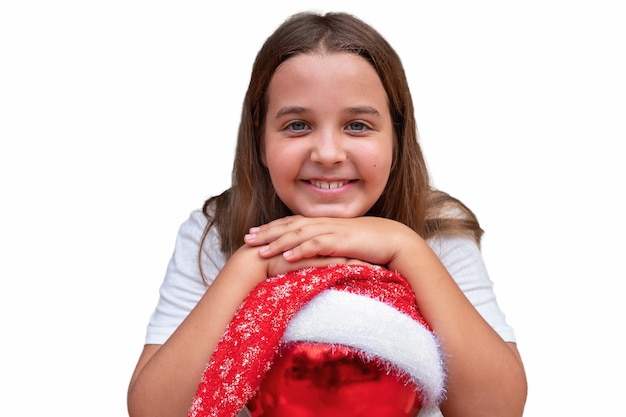 The child girl with christmas ornament in the santa hat isolated in white