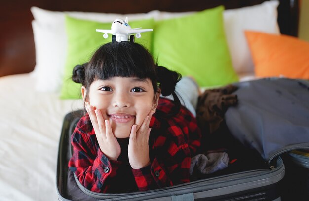 Child girl with a toy airplane on head