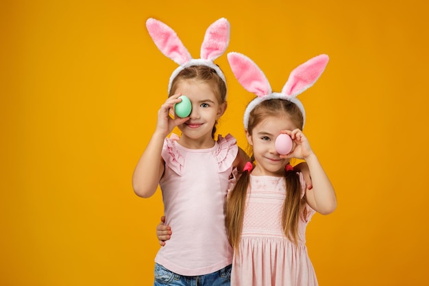 Child girls holding painted easter eggs