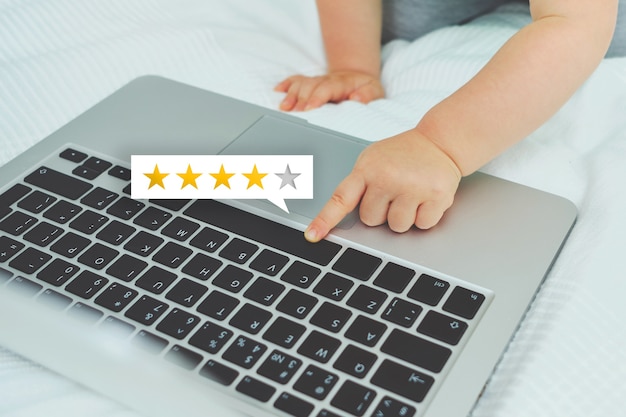 Child gives rating from stars using laptop.