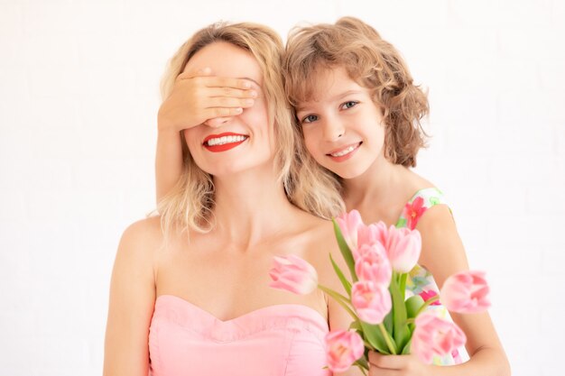 Child giving woman bouquet of tulips