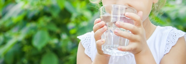 Photo child glass of water. selective focus. food and drink.