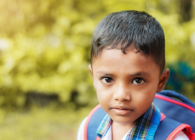 Child go to school on blurred bokeh nature