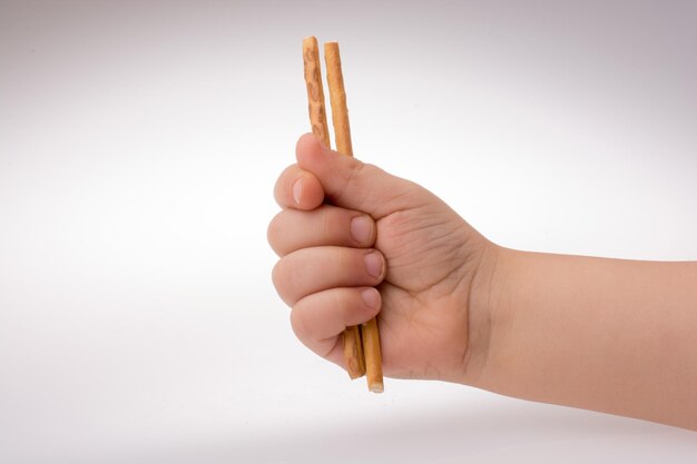 Photo child hand holding crackers in hand