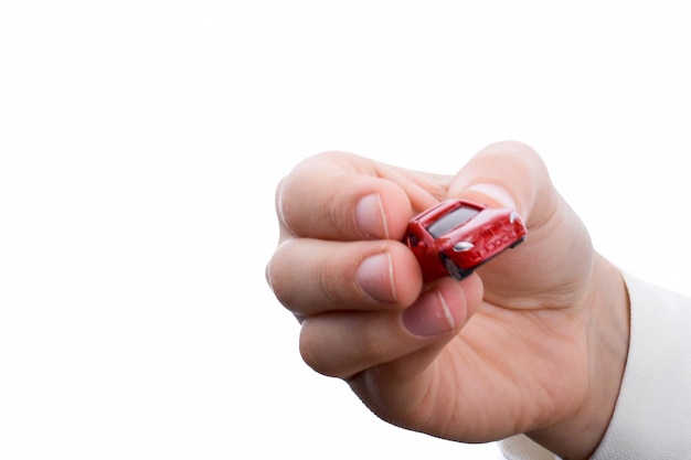 Child hand holding a red car