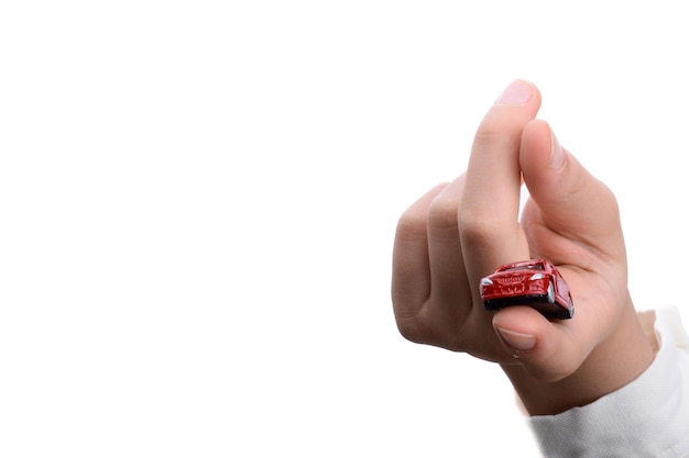 Child hand holding a red car