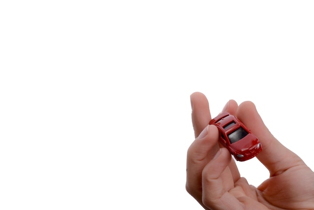 Child hand holding a red car