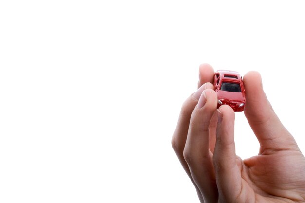 Child hand holding a red car