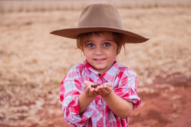 Child hand holding the soil prepare for plant the tree Agrarian with soil in his hands quality control concept agrarian business food cultivation Kids