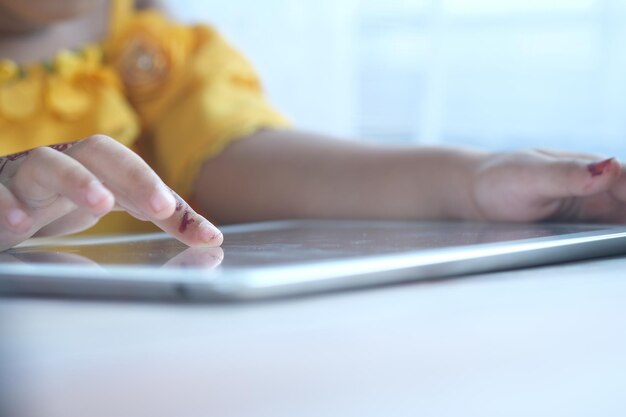 child hand pointing finger on digital tablet screen