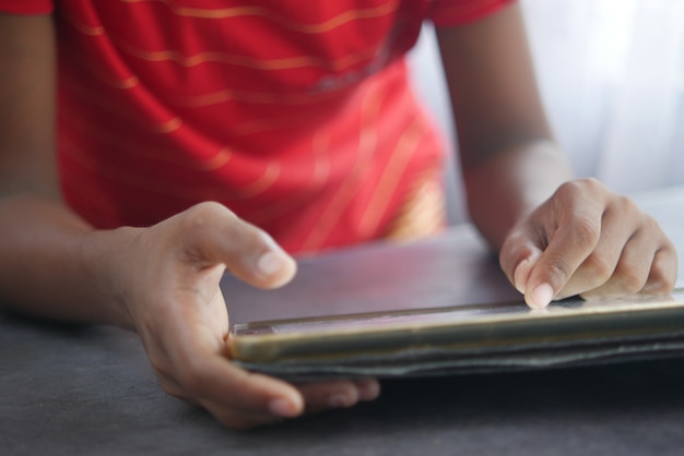 Child hand pointing finger on digital tablet screen