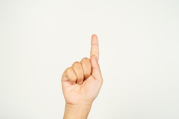 Photo child hand with finger pointing up pointing at something on white background hand closed