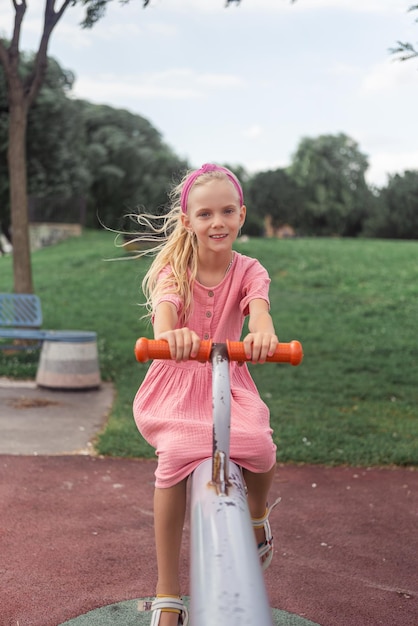 Child happily riding the seesaw in the urban parks playground radiating smiles and laughter