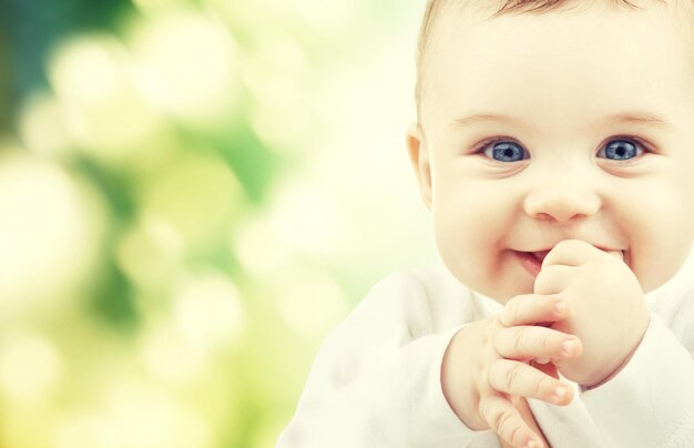 child, happiness and people concept - adorable baby