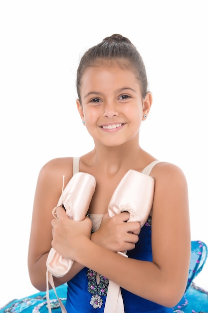 Child happy holds ballet shoes important attribute excellent ballerina.