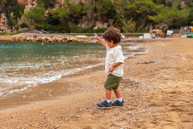 A child having fun on the beach in the port of Sant Miquel Ibiza Island Balearic Islands