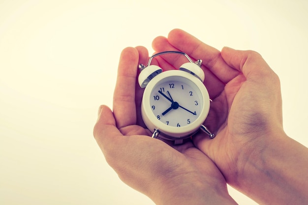 Child holding an alarm clock