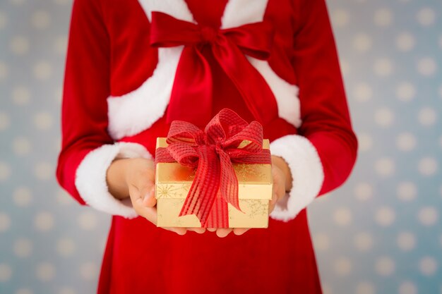 Child holding Christmas gift. Xmas holiday concept