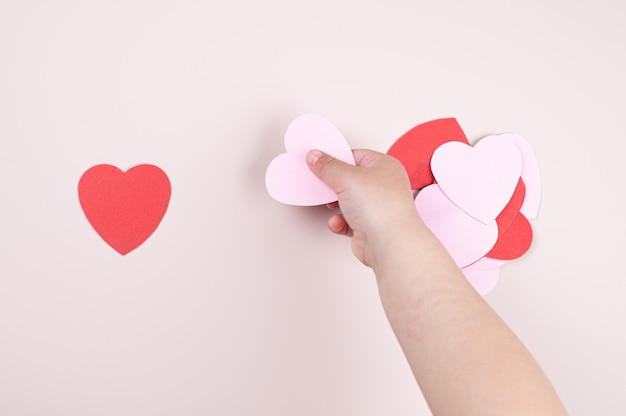 A child holding a heart in his hand.