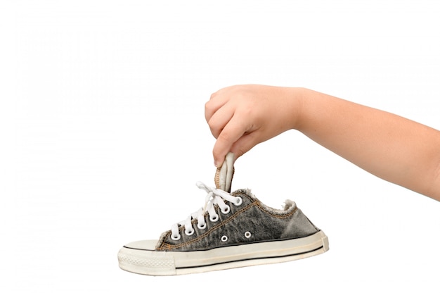 Child Holding An Old Dirty and Smelly Sneaker 