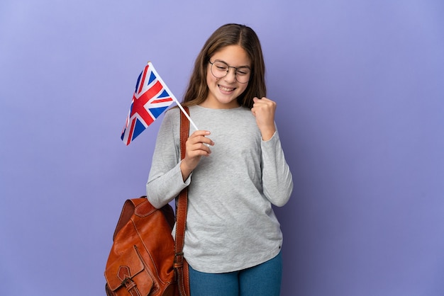 Child holding an United Kingdom flag over isolated background celebrating a victory