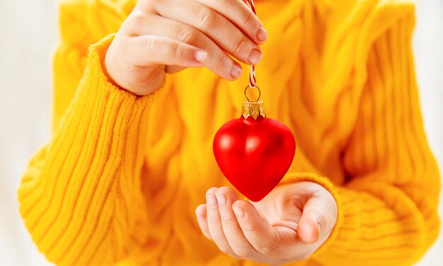 Child holds a christmas decor and gifts on a white background selective focus person