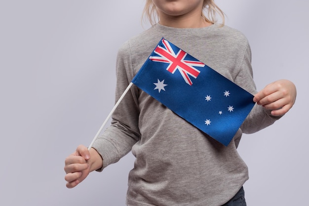 Child holds flag of Australia Close up Traveling with children in Australia