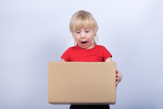 Child holds in hands big box