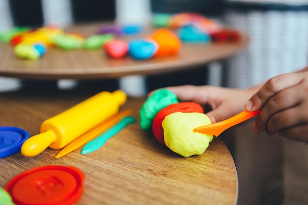 The child holds plasticine in his hands modeling workshop\
concept