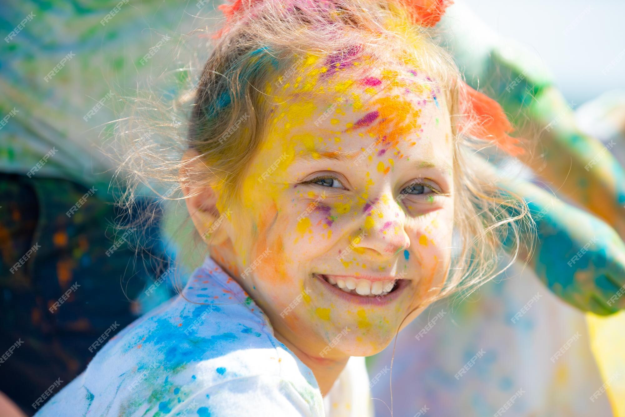 Premium Photo | Child holi festival. painted face of funny kid. little boy  plays with colors.