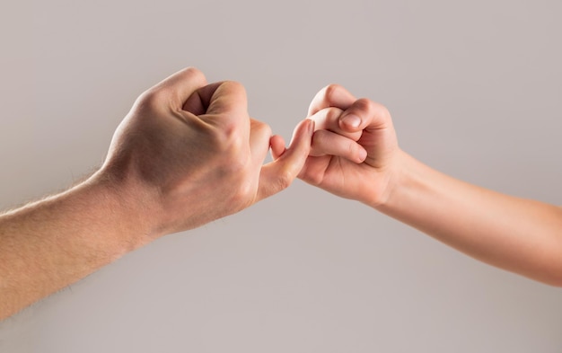 Premium Photo  Child hook little finger together little finger of the two  hands hold together show friendship and forgiveness friendship of  generations father daughter hand making promise friendship concept