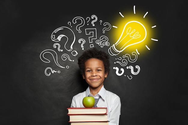 Child and Idea concept Smart boy student with lightbulb and question marks