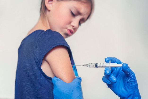 The child is afraid of a syringe the girl yells and does not want to give an injection Children's fear of medical procedures Vakination Girl afraid of injections at the doctor's office