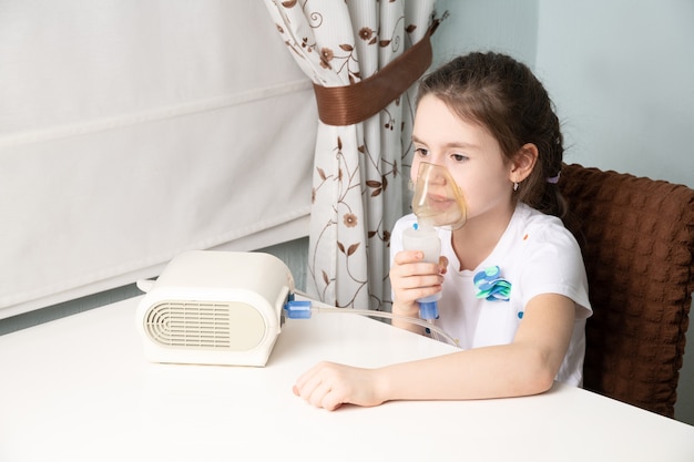 Photo the child is being treated for a cough with an inhaler