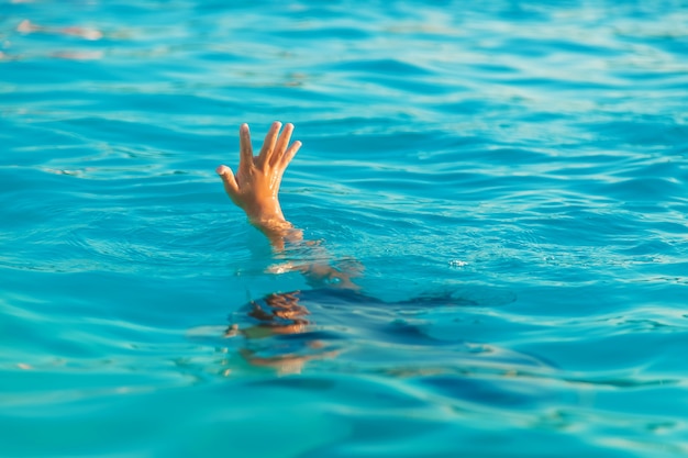 The child is drowning in water. Selective focus.