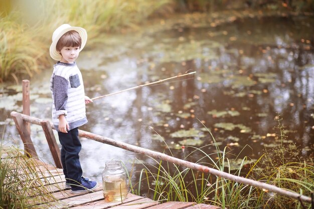 Premium Photo  Little boy fishing with a rod