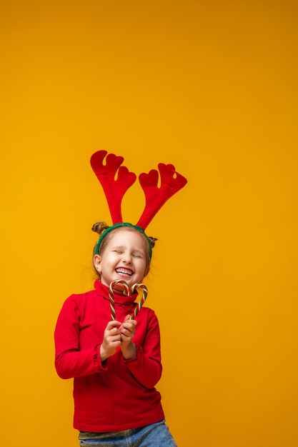 Photo the child is happy and holds lollipops in his hands